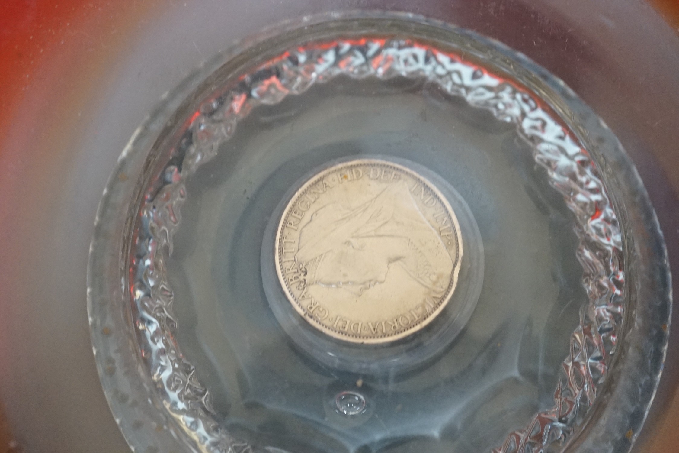 A pair of early 20th century ‘fancy’ glass dishes with inset coins to base, 29cm diameter